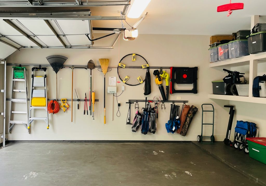 Clean organized garage with tools neatly hung on walls and open floor